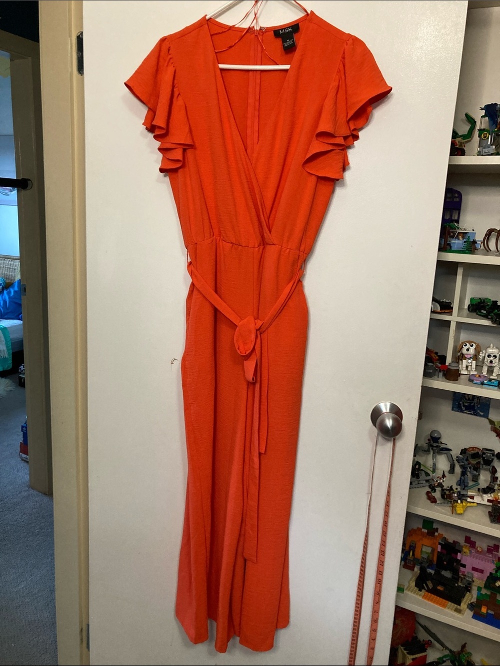 MSK jumpsuit features a vibrant orange color with flutter sleeves m